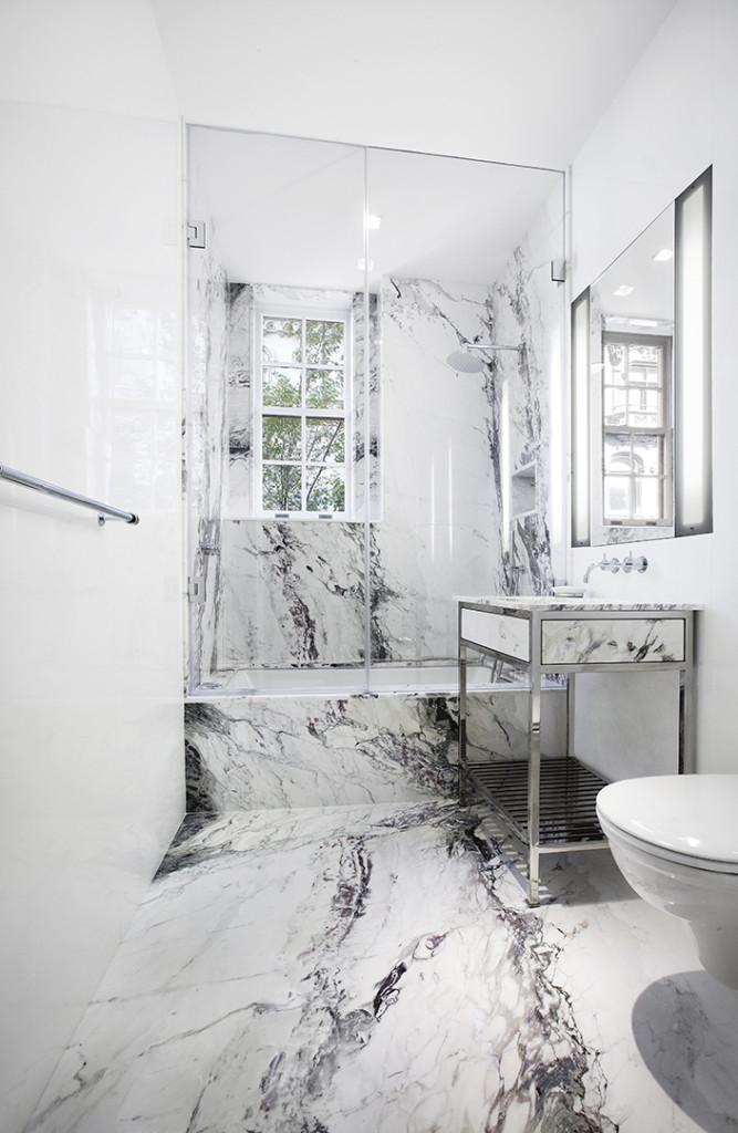 Blush tones against pure white marble shower walls